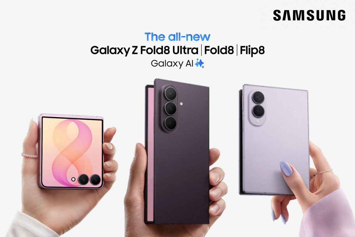 Trys rankos laiko tris skirtingus sulankstomus telefonus su įvairiomis korpuso spalvomis